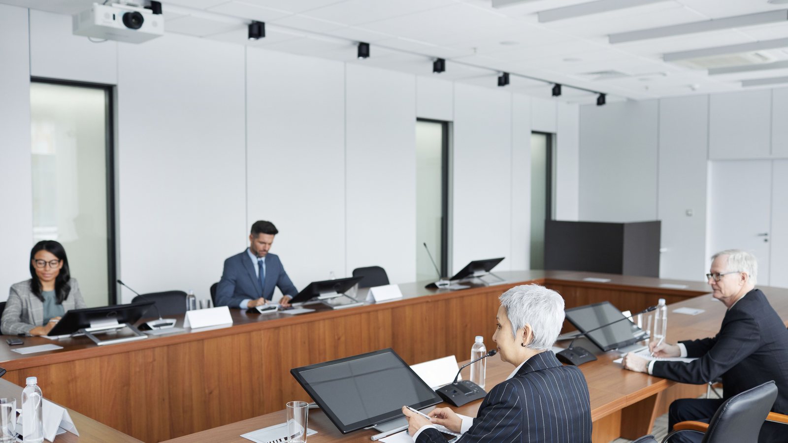 A board going through papers around a meeting table