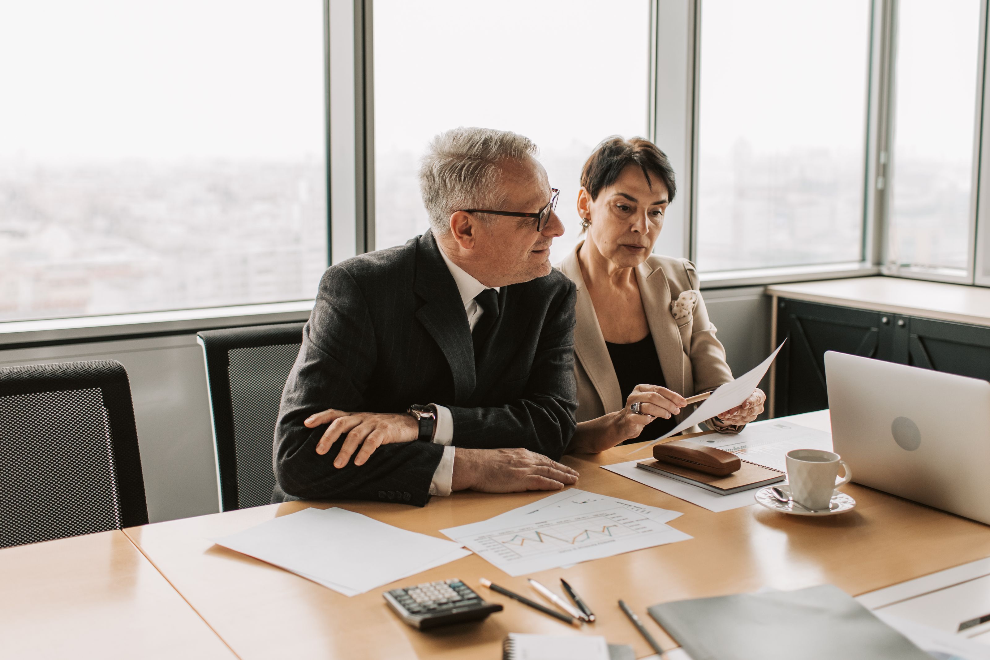 Two colleagues going through figures on paper