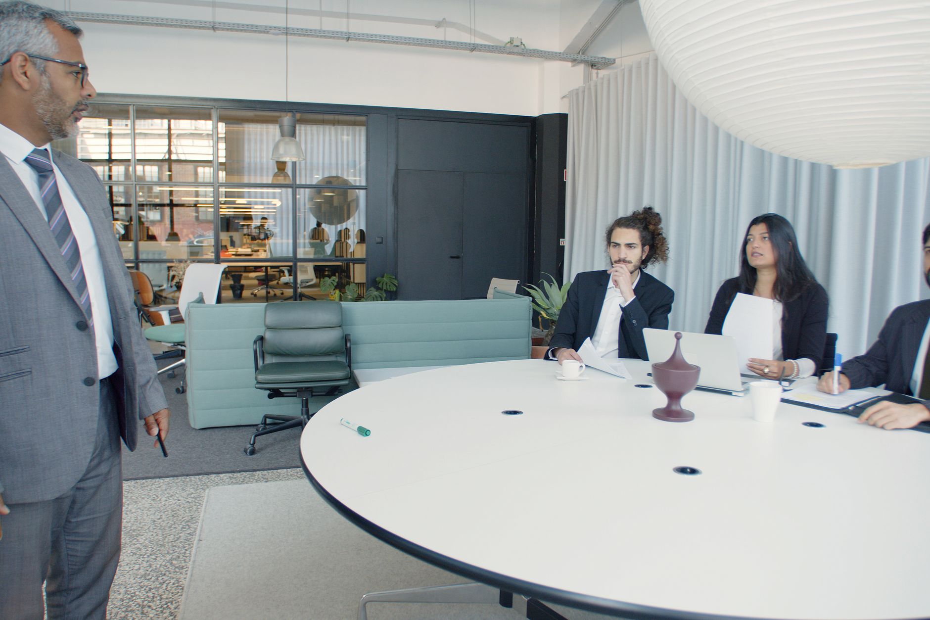 A team talking around a meeting table
