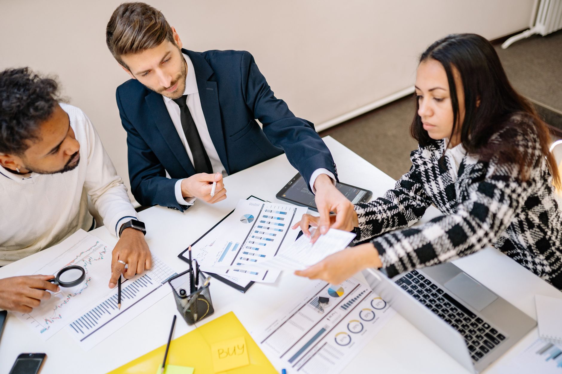 A team reviewing papers together at a table