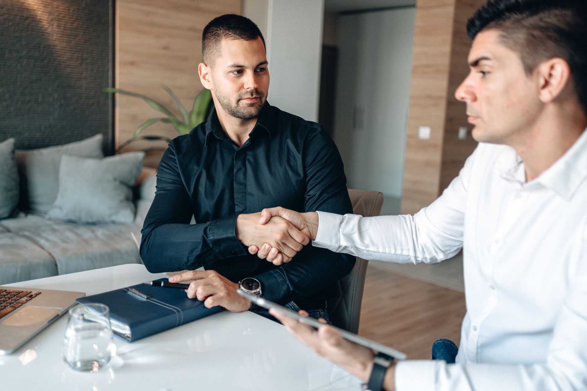 Two people shaking hands over an agreement