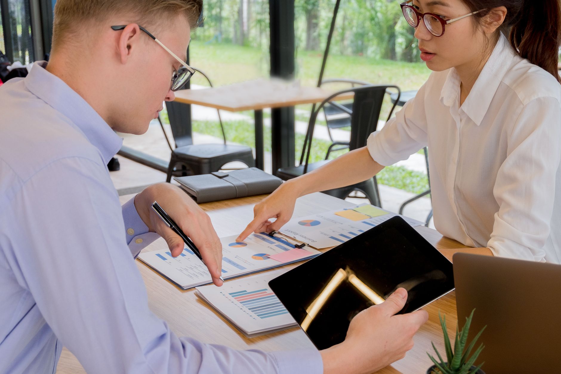 Documents and a tablet spread across a desk