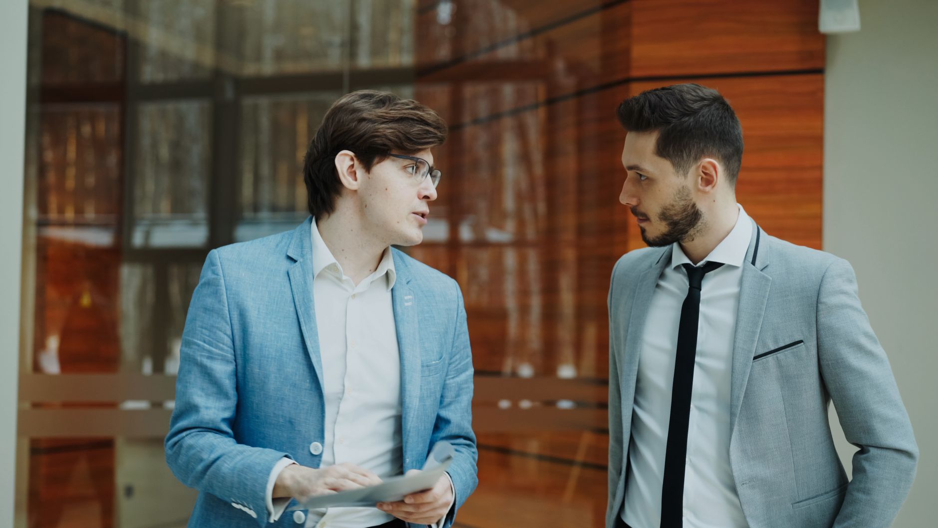 Two colleagues in conversation across a table