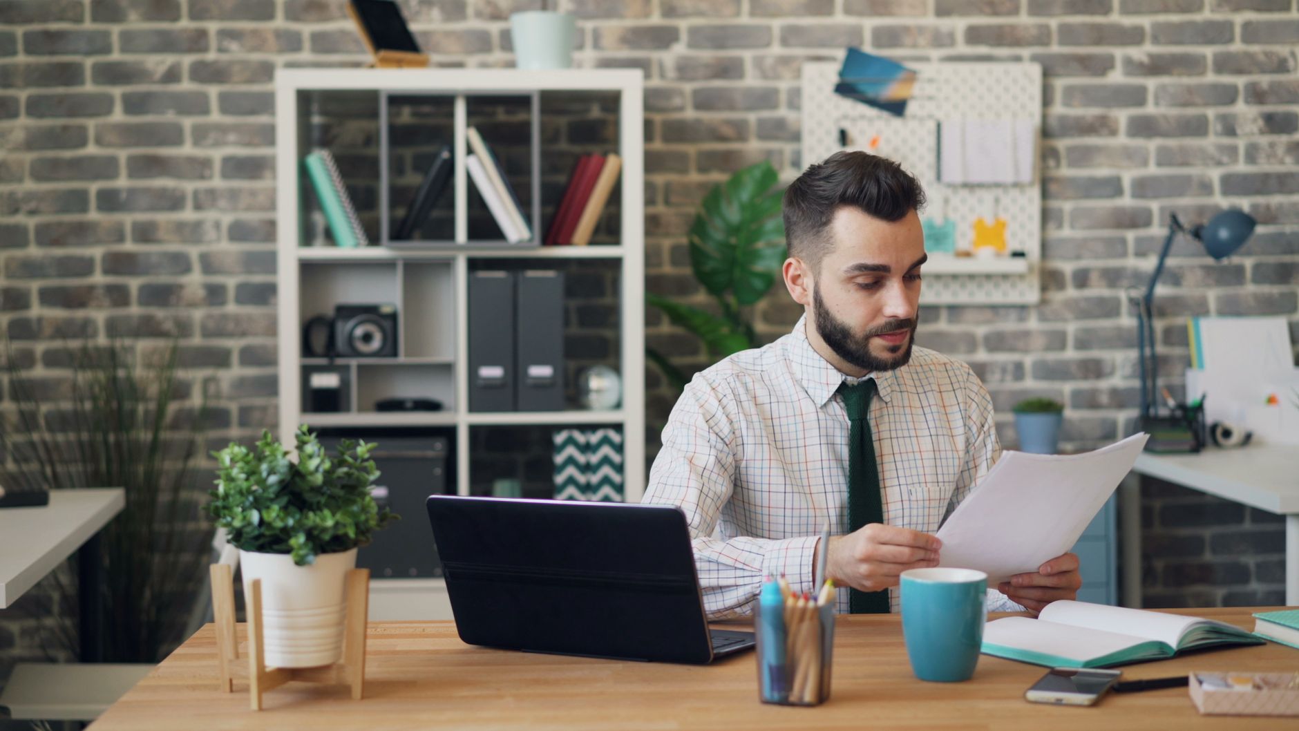 Someone reading through candidate papers at a desk