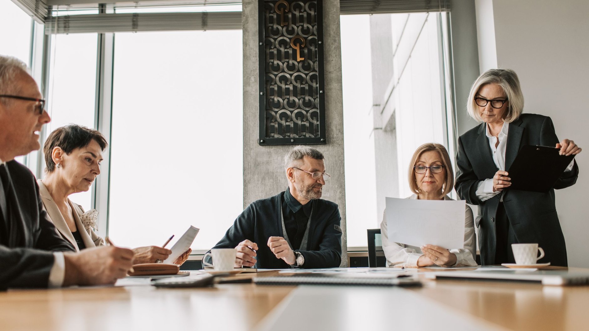 A leadership team working through papers in a meeting room